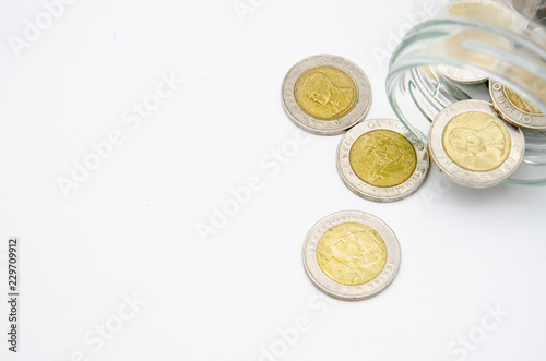 Money 10 Thai Baht is in a glass bottle. White background In the concept of saving money for the future.