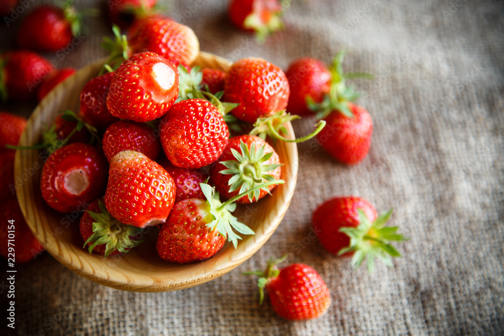 ripe red strawberry on a table with burlap