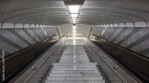 Stairs of a staircase and rope escalators in the subway station of a German metropolis.