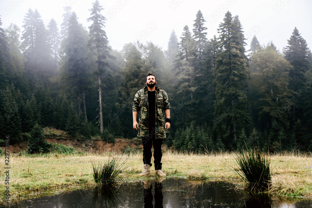 young man in military costume in forest young man in military costume in forest