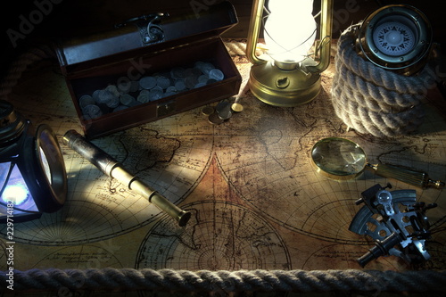 Old ship lantern,compass,coins,monocle,loupe, sextants,rope and pirate map. Travel and marine engraving background. Treasure hood concept. Vintage style.