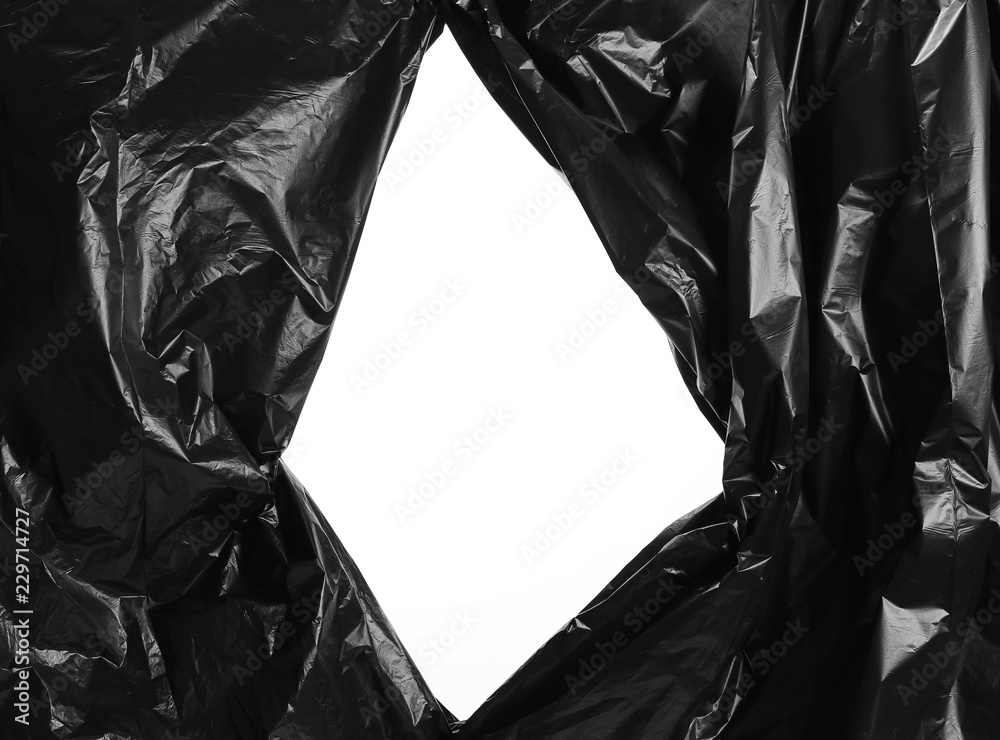 Premium PSD  Black nylon bag torn and cut on isolated transparent