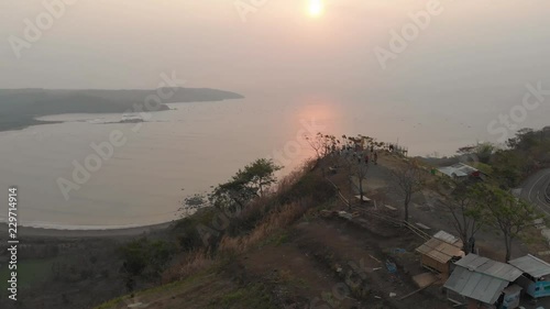 Aerial view clip of Puncak Darma at sunset, overlooking Geopark Ciletuh coastline in Sukabumi, Indonesia. photo