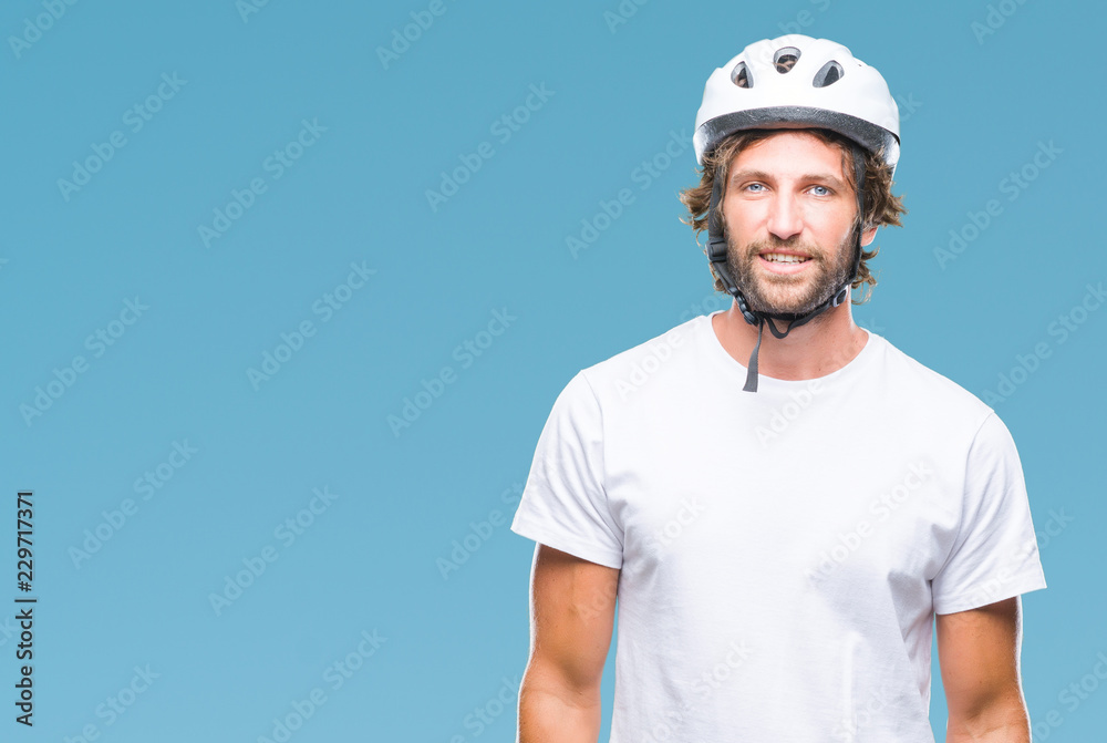 Handsome hispanic cyclist man wearing safety helmet over isolated background with a happy and cool smile on face. Lucky person. Handsome hispanic cyclist man wearing safety helmet over isolated background with a happy and cool smile on face. Lucky person.