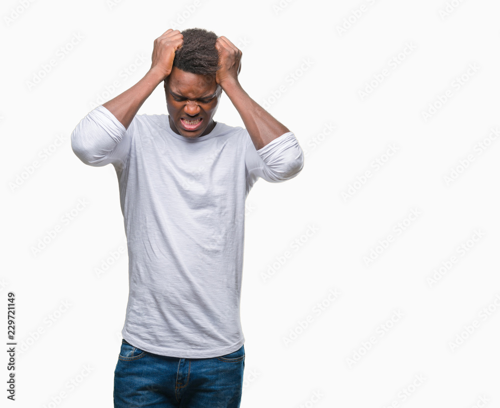 Young african american man over isolated background suffering from headache desperate and stressed because pain and migraine. Hands on head. Young african american man over isolated background suffering from headache desperate and stressed because pain and migraine. Hands on head.