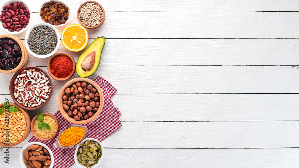 Superfoods Healthy food. Nuts, berries, fruits, and legumes. On a white wooden background. Top view. Free copy space. Superfoods Healthy food. Nuts, berries, fruits, and legumes. On a white wooden background. Top view. Free copy space.