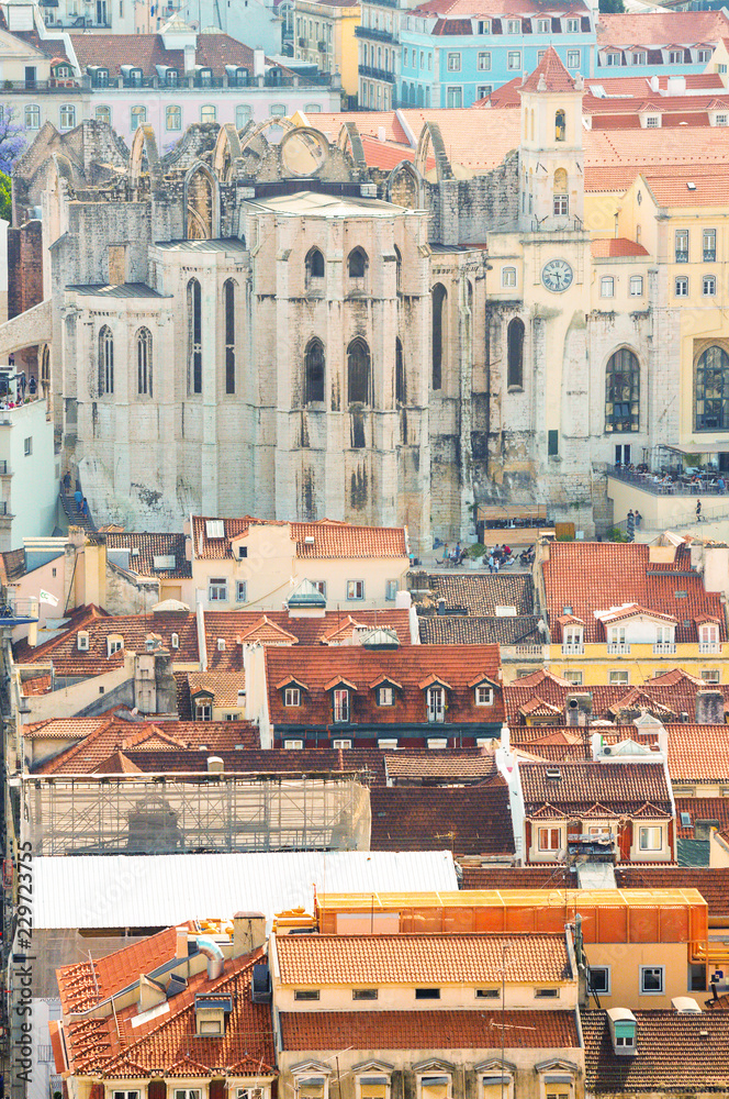 View to  Carmo Convent  in Lisbon and  houses with roofs covered  with red tile.