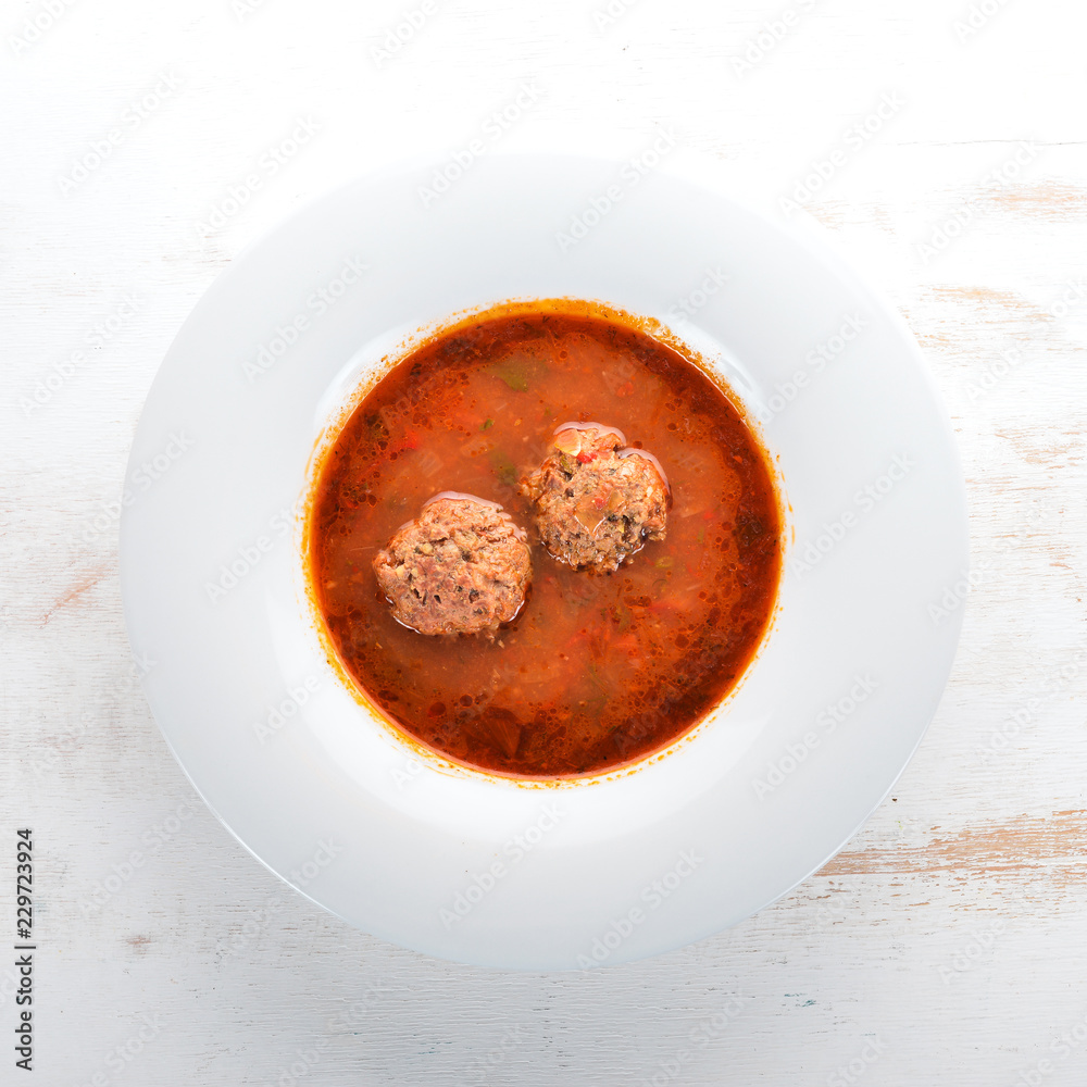 Vegetable soup with meat balls. On the old wooden background. Free space for text. Top view. Vegetable soup with meat balls. On the old wooden background. Free space for text. Top view.