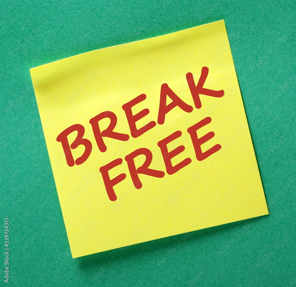 The words Break Free in red text on a yellow sticky note as a reminder The words Break Free in red text on a yellow sticky note as a reminder