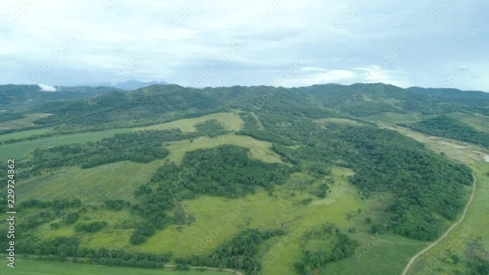 Aerial drone view beautiful natural scenery of green hills with mountains in background, Aerial drone view beautiful natural scenery of green hills with mountains in background,
