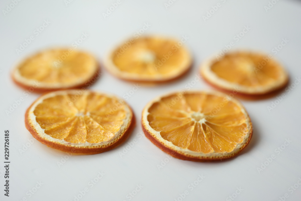 five dried orange slices on white background five dried orange slices on white background