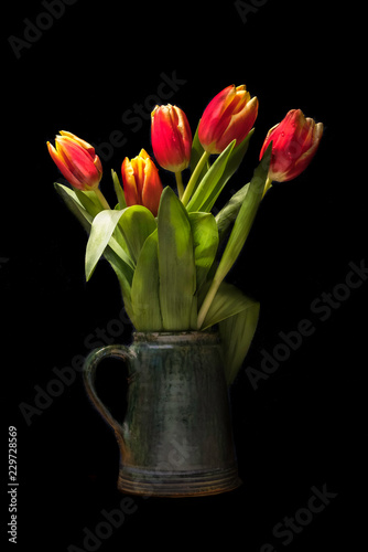 Wallpaper Mural Bouquet of red tulips in old vase isolated on black background Torontodigital.ca