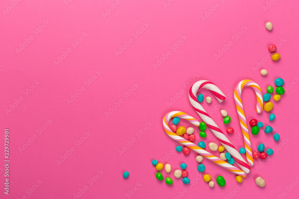 Colorful lollipops on a pink background