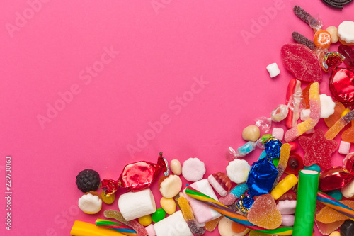 Colorful lollipops on a pink background
