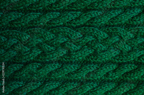 Texture of warm green knitted winter clothes.