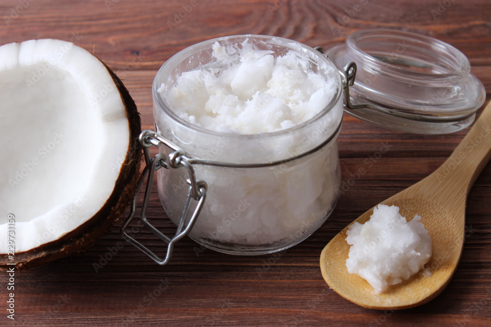 coconuts and coconut oil on a wooden background. coconuts and coconut oil on a wooden background.