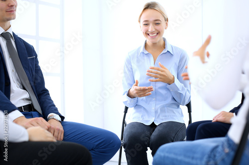 Group of people sitting in a circle during therapy. Meeting of business team participating in training