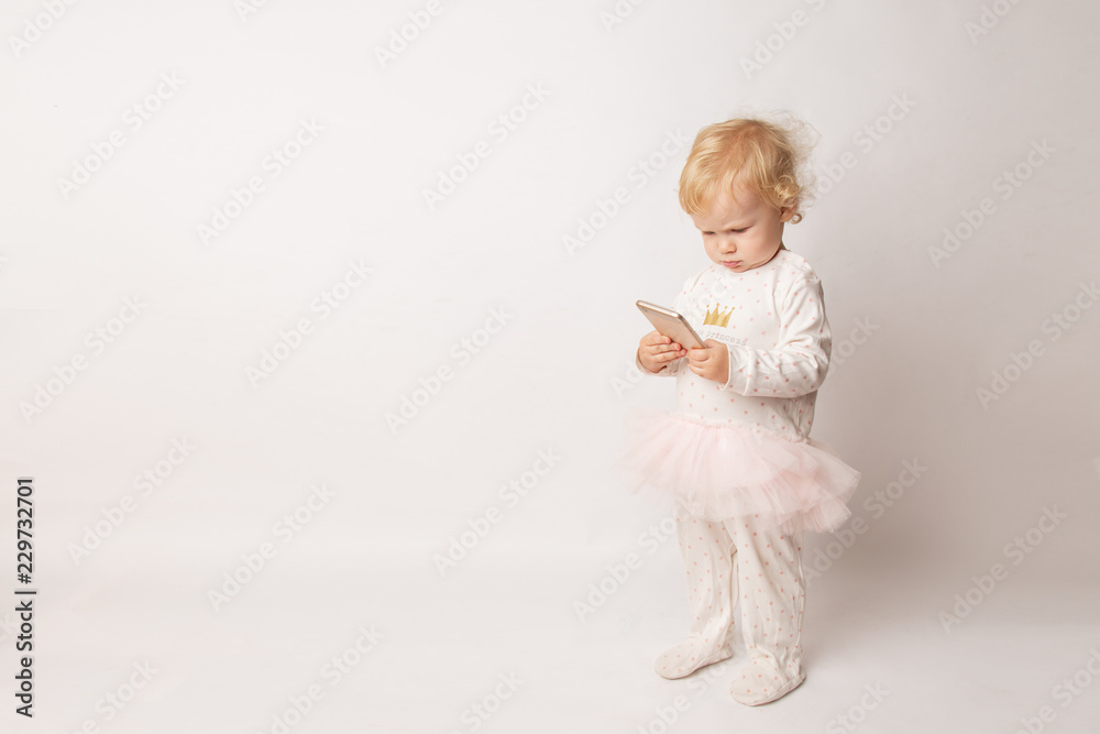 funny Caucasian little girl feeling angry as she lost game. Mad female child having displeased look because of low battery on cell phone or bad cellular connection funny Caucasian little girl feeling angry as she lost game. Mad female child having displeased look because of low battery on cell phone or bad cellular connection