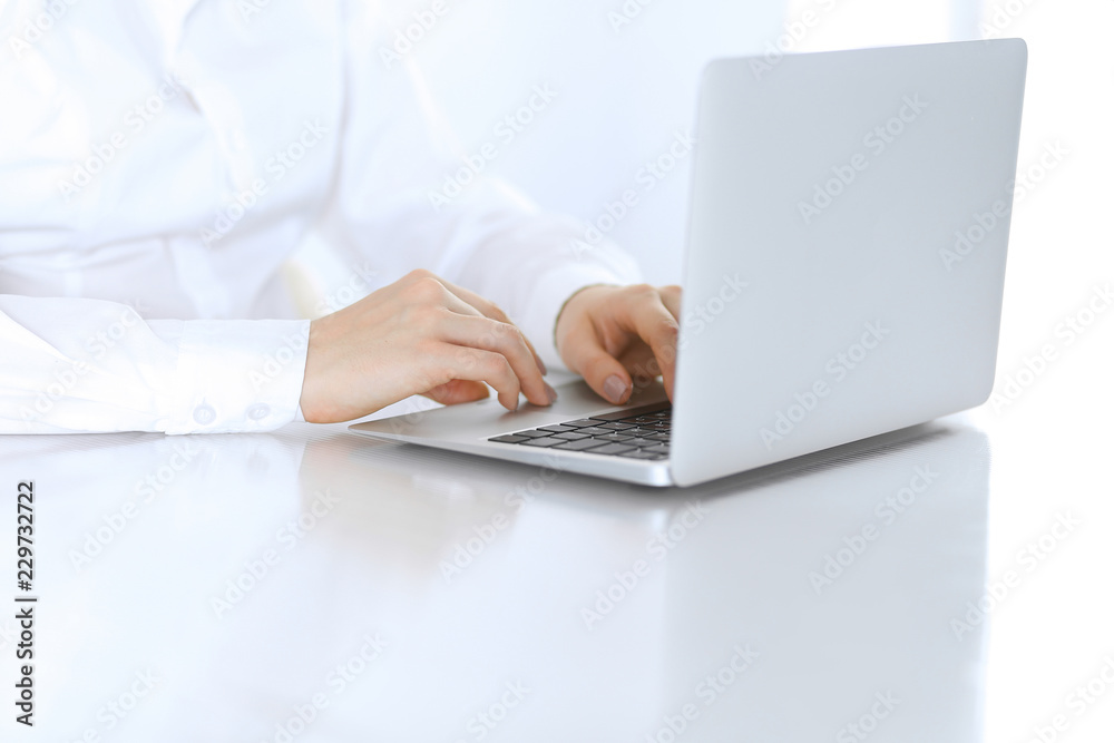 Close-up of business woman hands typing on laptop computer. Secretary at work in office Close-up of business woman hands typing on laptop computer. Secretary at work in office