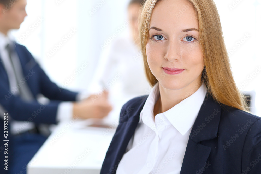Group of business people or lawyers discussing terms of transaction in office. Focus at young business woman. Meeting and teamwork concept Group of business people or lawyers discussing terms of transaction in office. Focus at young business woman. Meeting and teamwork concept