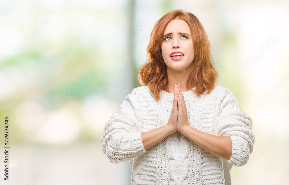Young beautiful woman over isolated background wearing winter sweater begging and praying with hands together with hope expression on face very emotional and worried. Asking for forgiveness