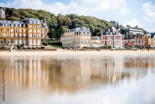 View on the cooastline with sandy beach and luxury buildings in Trouville, famous french town in Normandy
