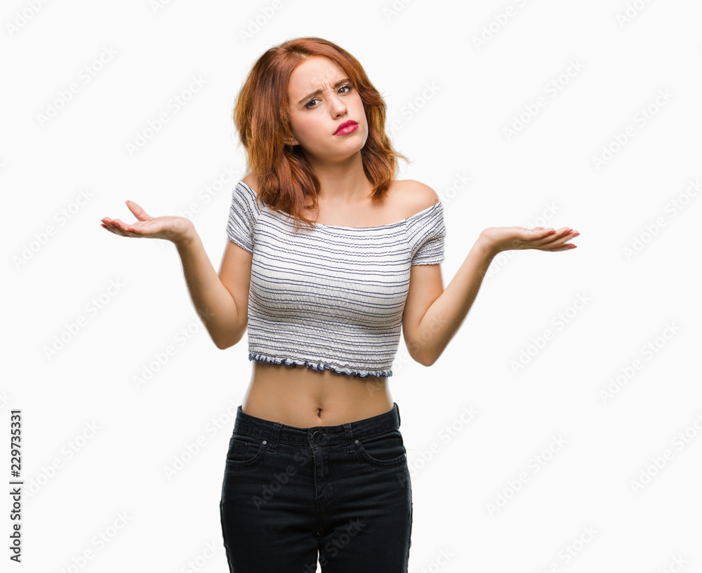 Young beautiful woman over isolated background clueless and confused expression with arms and hands raised. Doubt concept.