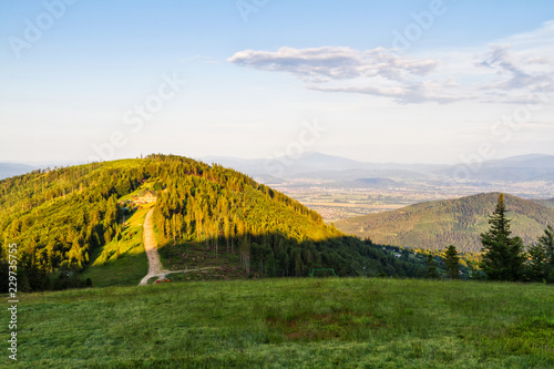 View of Klimczok peak with a mountain hostel on it. Spring panorama in Polish Beskid Slaski mountains, Europe. photo
