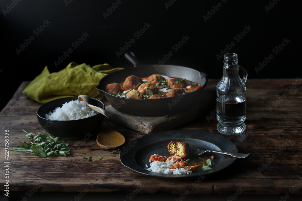 Bottle of water near boiled rice and cauliflower and quinoa meat balls Bottle of water near boiled rice and cauliflower and quinoa meat balls