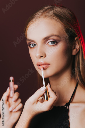 Lips. Skin care. Pomade. Portrait. Stylish makeup.   ortrait of beautiful young woman with clean and fresh skin. Nude makeup. Concept for cosmetology ads with copy space  beauty magazine and spa.