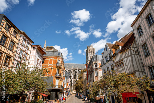 Cozy square with beautiful buildings and cathedral on the background in Rouen city, France