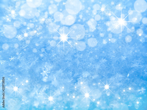 Blue Snow Texture with Snowflakes and Stars close-up. Beautiful winter and Christmas background.