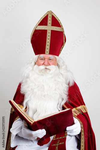 Saint Nicholas looking at you smiling over his big book
