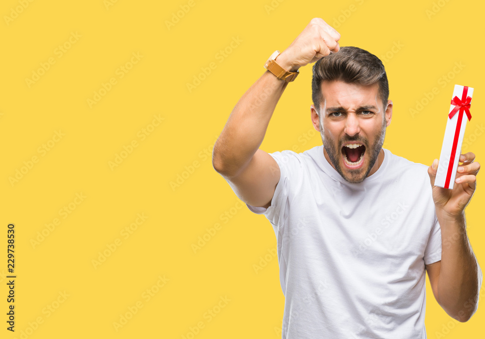 Young handsome man in love giving valentine present over isolated background annoyed and frustrated shouting with anger, crazy and yelling with raised hand, anger concept Young handsome man in love giving valentine present over isolated background annoyed and frustrated shouting with anger, crazy and yelling with raised hand, anger concept