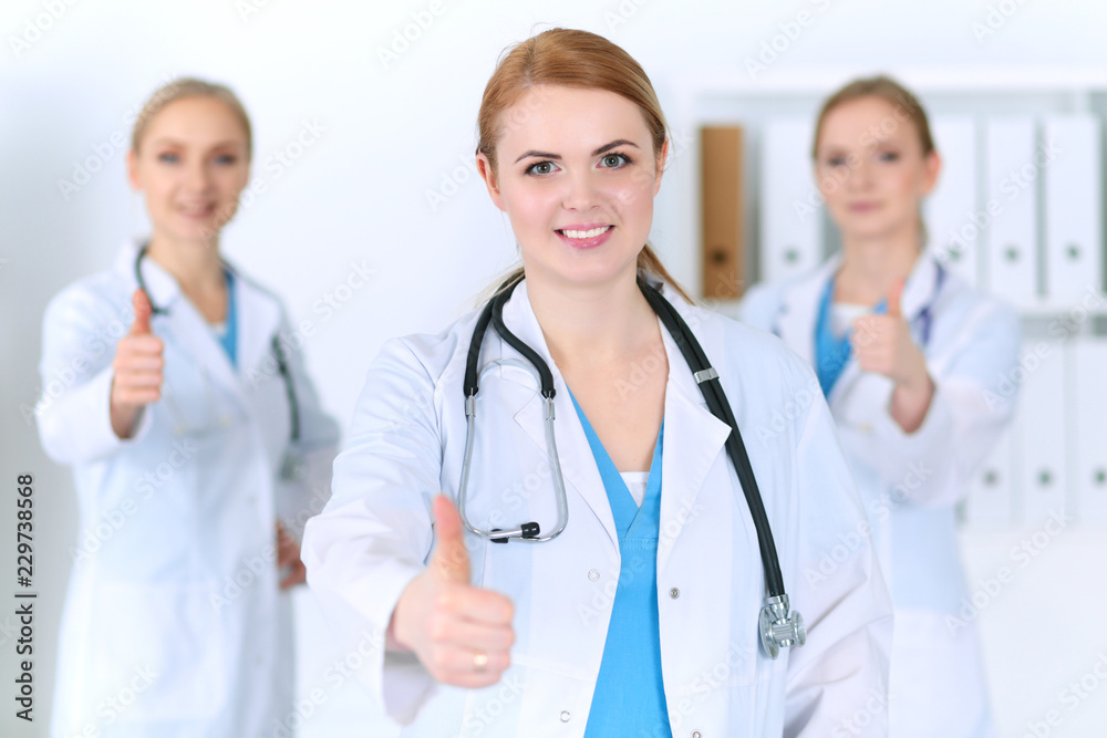 Groupe of medicine doctors show OK sign with thumb up. Success and high level service in health care, best treatment and customer loyalty and physical concept. Copy space for advertisement