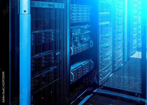 working computer server for latticed doors. room with rows of server hardware in the data center