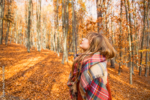 Young girl in autumn season in the park, shot of a girl with scarf in fall outdoor