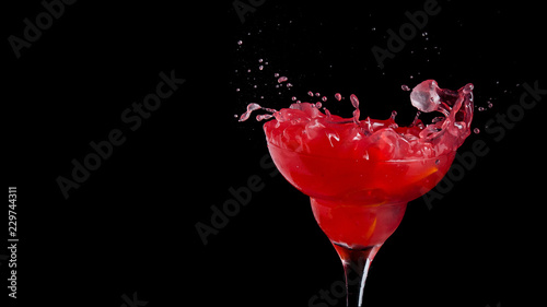 Red alcohol cocktail with splashes