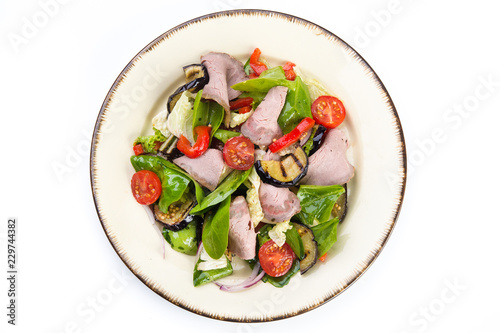 Fresh salad with ham, red pepper, eggplant and basil leaves