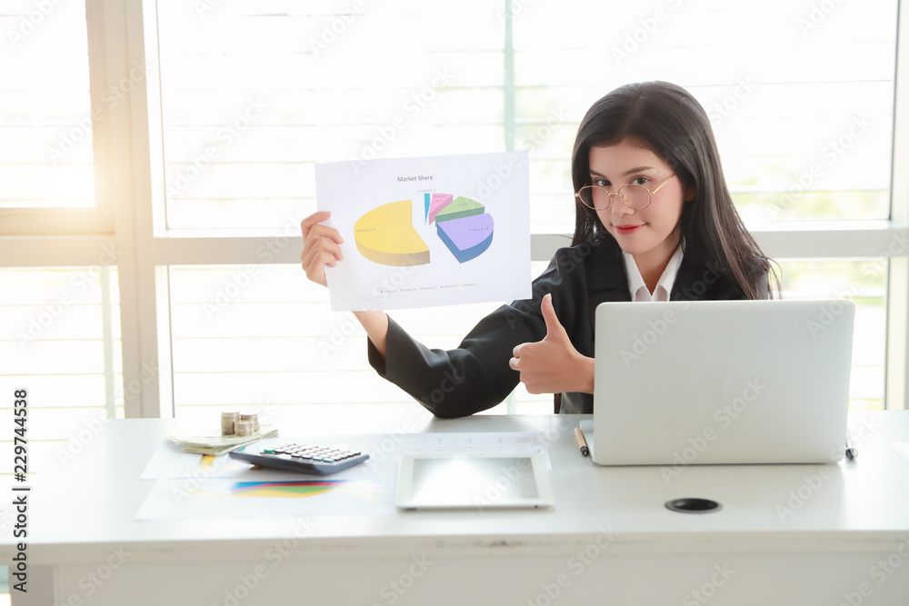 businesswoman showing thumb up and company profit with graph in meeting room businesswoman showing thumb up and company profit with graph in meeting room