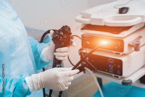 Endoscopy at the hospital. Doctor holding endoscope before gastroscopy photo
