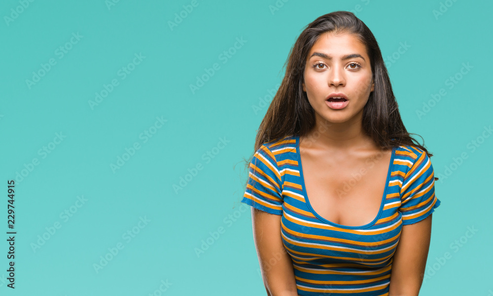 Obraz premium Young beautiful arab woman over isolated background afraid and shocked with surprise expression, fear and excited face.