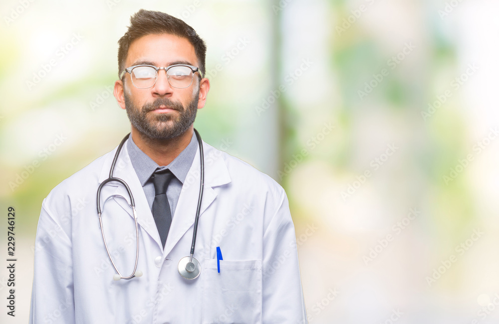 Adult hispanic doctor man over isolated background with serious expression on face. Simple and natural looking at the camera. Adult hispanic doctor man over isolated background with serious expression on face. Simple and natural looking at the camera.