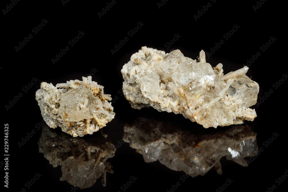 Macro mineral stone fluorite with quartz against black background Macro mineral stone fluorite with quartz against black background