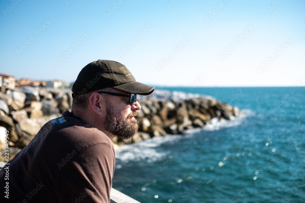 man watching the Mediterranean near Marina di Pisa in Italy