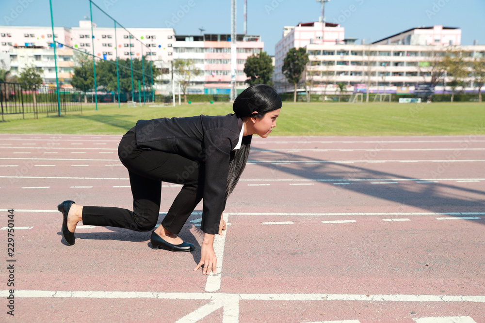Business competition: businesswoman on start line and ready to reach the target. Business competition: businesswoman on start line and ready to reach the target.
