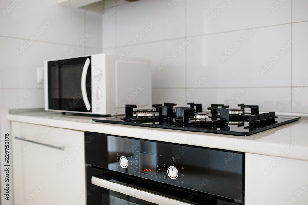 Modern kitchen interior with electric and microwave oven. 