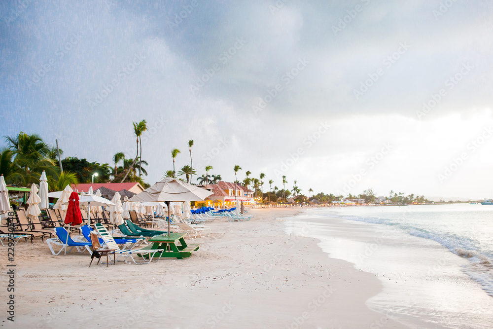 Idyllic caribbean tropical beach with white sand, turquoise ocean water before the rain