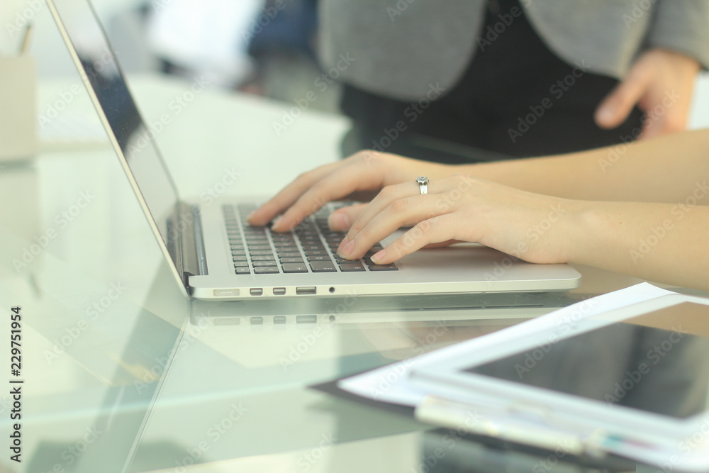 closeup business woman typing on a laptop. people and technology closeup business woman typing on a laptop. people and technology
