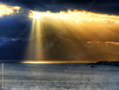 Dramatic landscape - sun over a mountain, Tromso, Norway